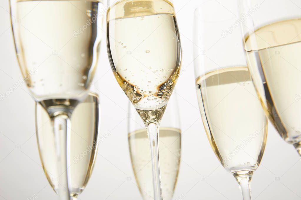 cropped image of champagne glasses with bubbles isolated on white backgronud