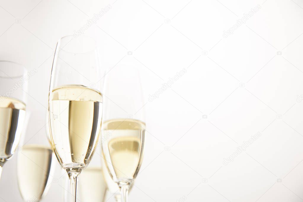 closeup view of champagne glasses isolated on white background