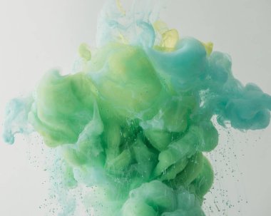 light background with mixing turquoise and green paint in water, isolated on grey clipart