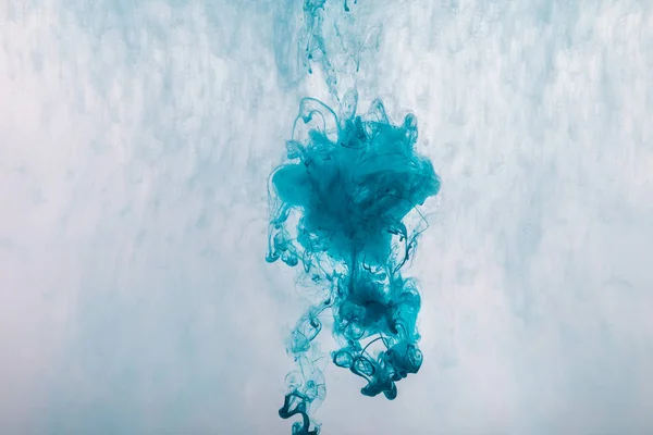 creative design with blue paint splash in water