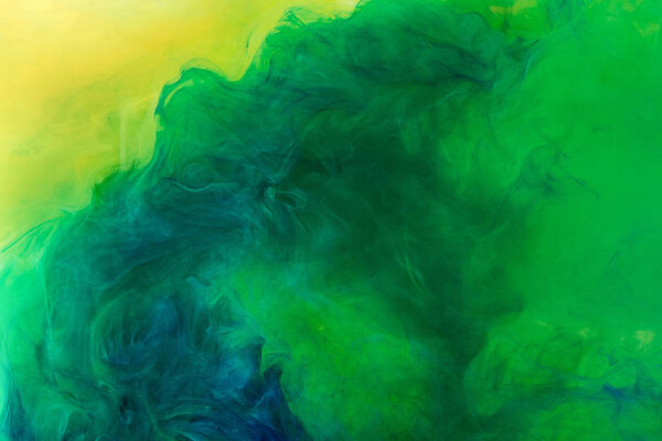 artistic texture with green paint flowing in water