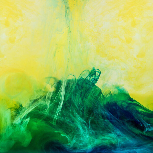 abstract background with swirls of green paint in yellow water