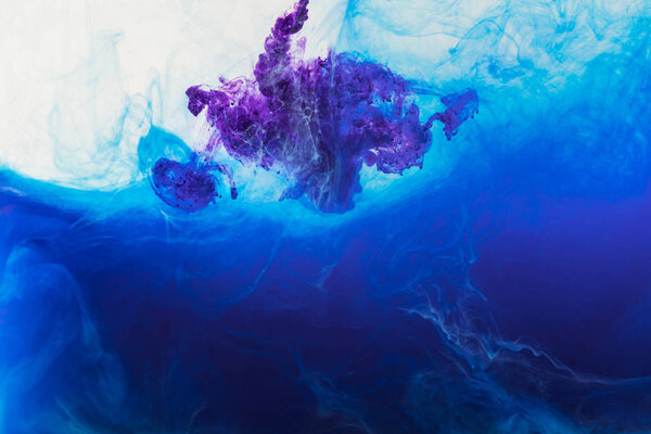 abstract background with blue and purple paint flowing in water