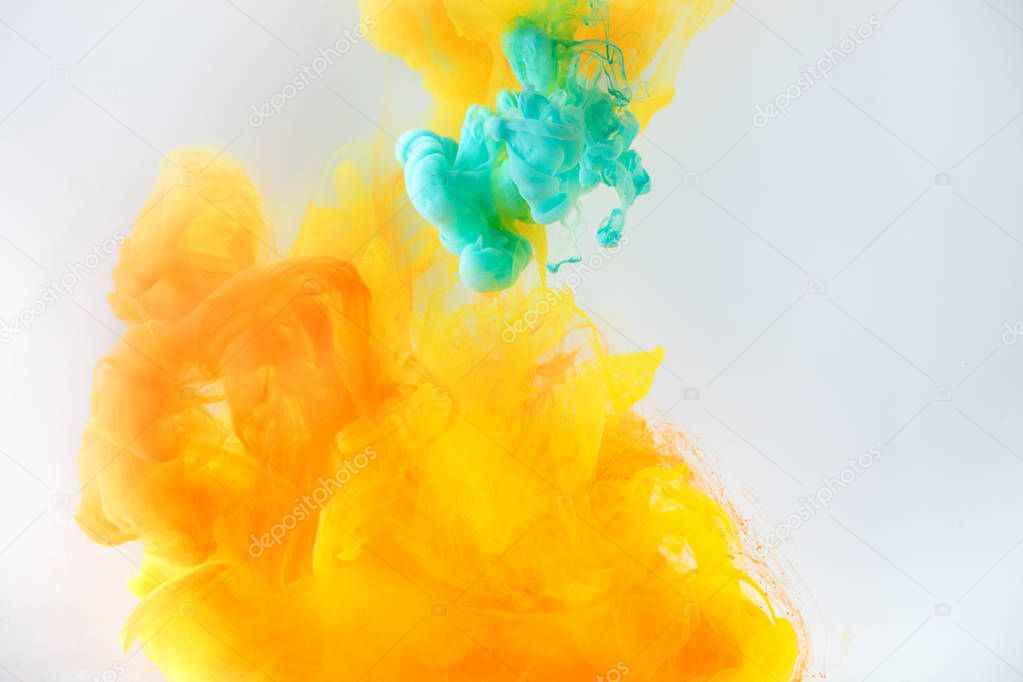 abstract background with turquoise and orange paint swirls in water, isolated on grey
