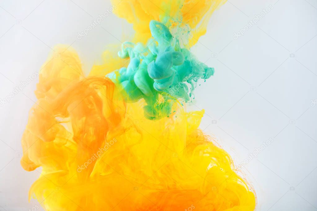 creative background with turquoise and orange paint flowing in water, isolated on grey