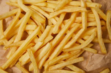 top view of french fries on crumpled paper clipart