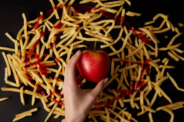 Cropped Shot Woman Holding Red Apple Surrounded French Fries Isolated — Free Stock Photo