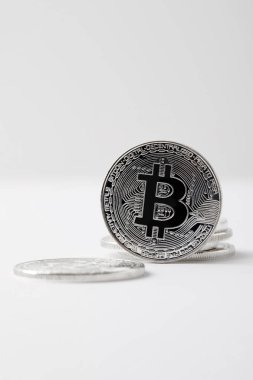 close-up shot of bitcoin standing on white tabletop clipart