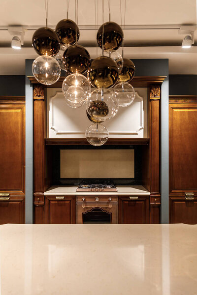 Stylish kitchen with elegant shiny table and chandelier