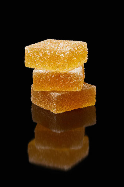 closeup view of stack of jelly candies on black background