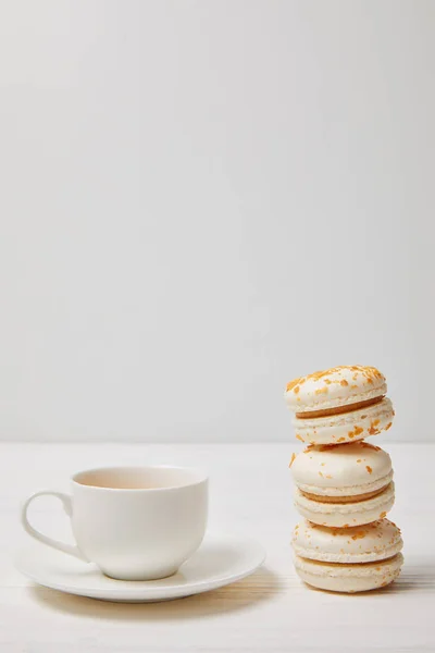 Closeup Shot Coffee Cup Stack Macarons White Wooden Table — Stock Photo, Image