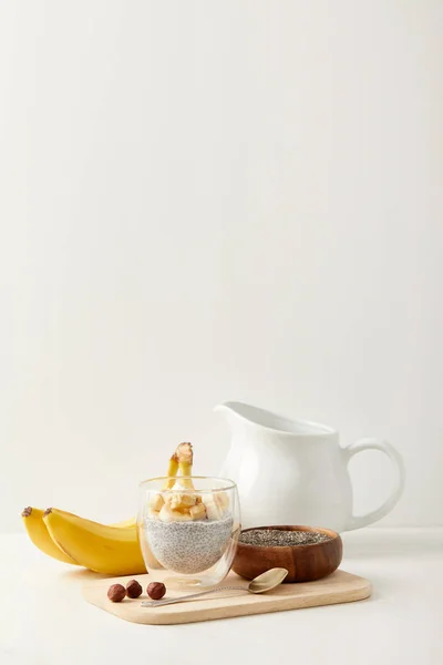 Close View Chia Seed Pudding Pieces Banana Hazelnuts Wooden Cutting — Free Stock Photo