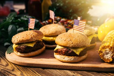 Burgers with us flags grilled for outdoors barbecue clipart