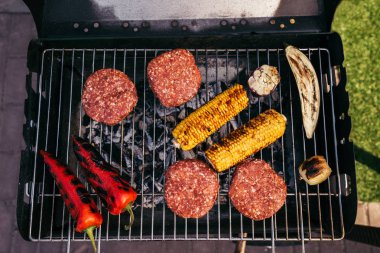 Meat chops and vegetables grilled for outdoors barbecue clipart