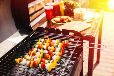 Summer vegetables and mushrooms on skewers grilled for outdoors barbecue clipart