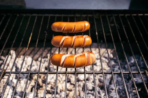 Three Sausages Grilled Outdoors Barbecue Fire — Free Stock Photo