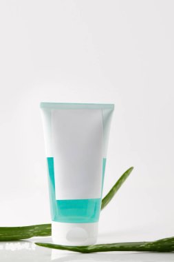 closeup view of cream tube and aloe vera leaves isolated on white background  clipart