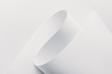 Close-up view of white rolled paper on white background clipart