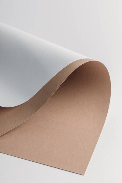 decorative white and brown paper sheets on grey background
