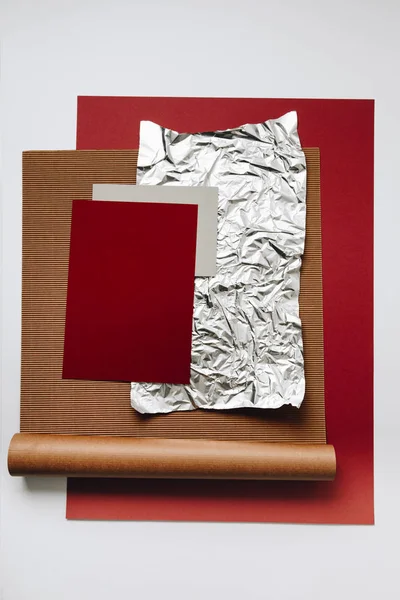 various blank paper, foil and cardboard textures on grey background