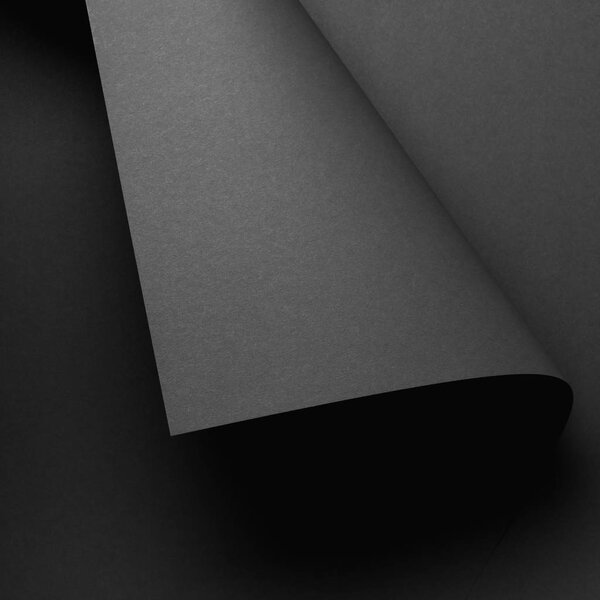 close-up view of grey paper sheet and dark abstract background