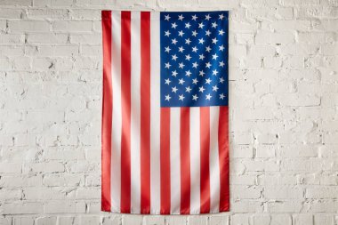 close up view of united states of america flag on white brick wall  clipart