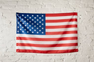 front view of united states of america flag on white brick wall clipart