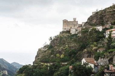 Savoca, İtalya - 3 Ekim 2019: Tepedeki San Nicolo Kilisesi Yeşil ağaçlar ve tepedeki küçük evler 