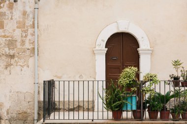 balcony with plants in flowerpots in sicily  clipart