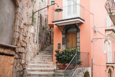 selective focus of stairs near small house in ragusa, italy  clipart