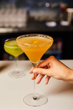 selective focus of woman touching cocktail in glass  clipart