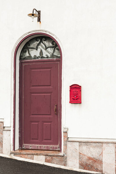 building with red door near vintage post box 