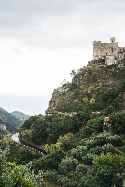 SAVOCA, ITALY - OCTOBER 3, 2019: Church of San Nicolo on hill near green trees