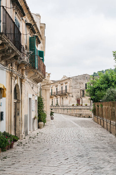 street with paving stones on road near buildings 