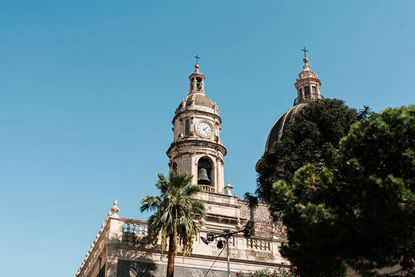 CATANIA, ITALY - OCTOBER 3, 2019: low angle view of clock tower of Saint Agatha cathedral 