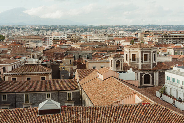 sunshine on roofs of small old houses in catania, italy 