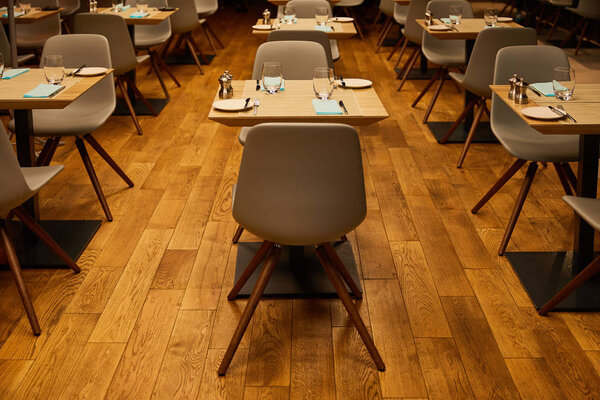 glasses near plates and napkins on wooden tables