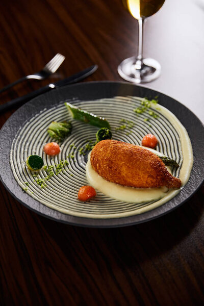 delicious chicken kiev and mashed potato served on plate on wooden table