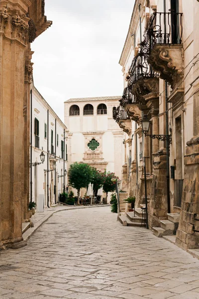 Street with paving stones near old buildings with balconies — Stock Image Street Paving Stones Old Buildings Balconies Stock Image