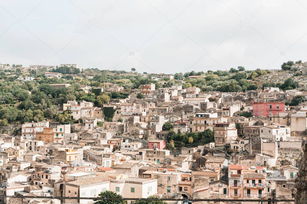 sunshine on roofs of old houses in modica, italy 