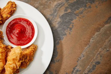 top view of delicious chicken nuggets with ketchup on stone surface clipart