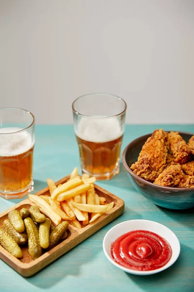 Delicious Chicken Nuggets Ketchup French Fries Gherkins Glasses Beer Turquoise — Stock Photo, Image