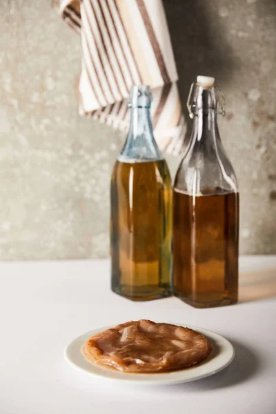 Selective Focus Bottles Drink Kombucha Mushroom Textured Grey Wall — Stock Photo, Image