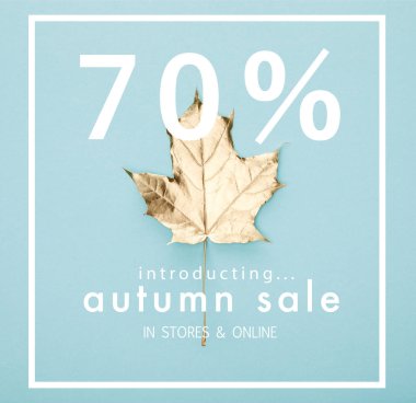 top view of autumnal golden maple leaf on blue background with autumn sale, 70 percent illustration  clipart