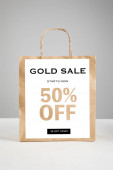 paper shopping bag with gold sale 50 percent off illustration isolated on grey, black Friday concept