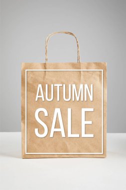 paper shopping bag with autumn sale illustration isolated on grey, black Friday concept clipart