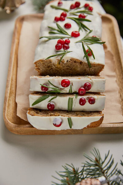 close up view of traditional Christmas cake with cranberry on white table
