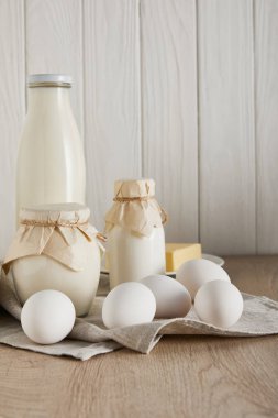 delicious fresh dairy products and eggs on white wooden background clipart