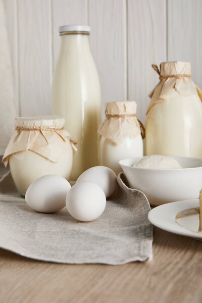 delicious fresh dairy products and eggs on white wooden background