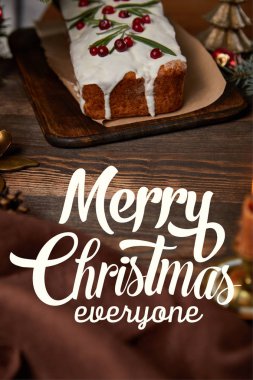 traditional Christmas cake with cranberry on wooden table with brown napkin with Merry Christmas everyone illustration clipart